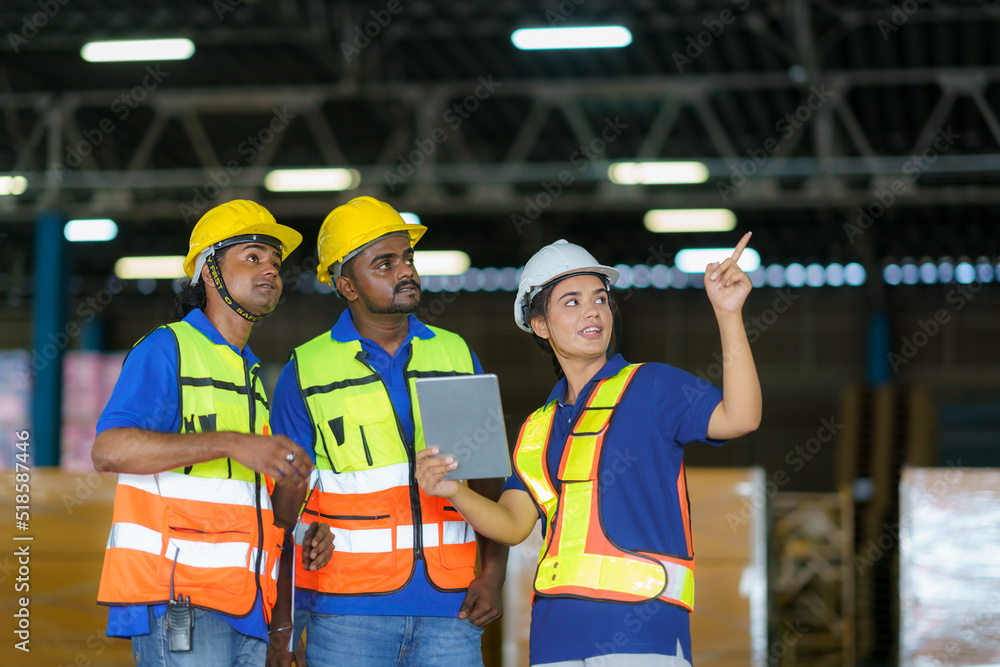 Asian team warehouse workers checking shipment status on digital tablet computer prepare for deliver