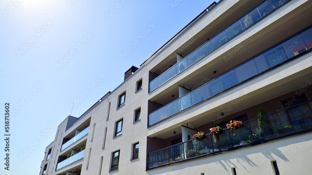 Exterior of new apartment buildings on a blue cloudy sky background. No people. Real estate business