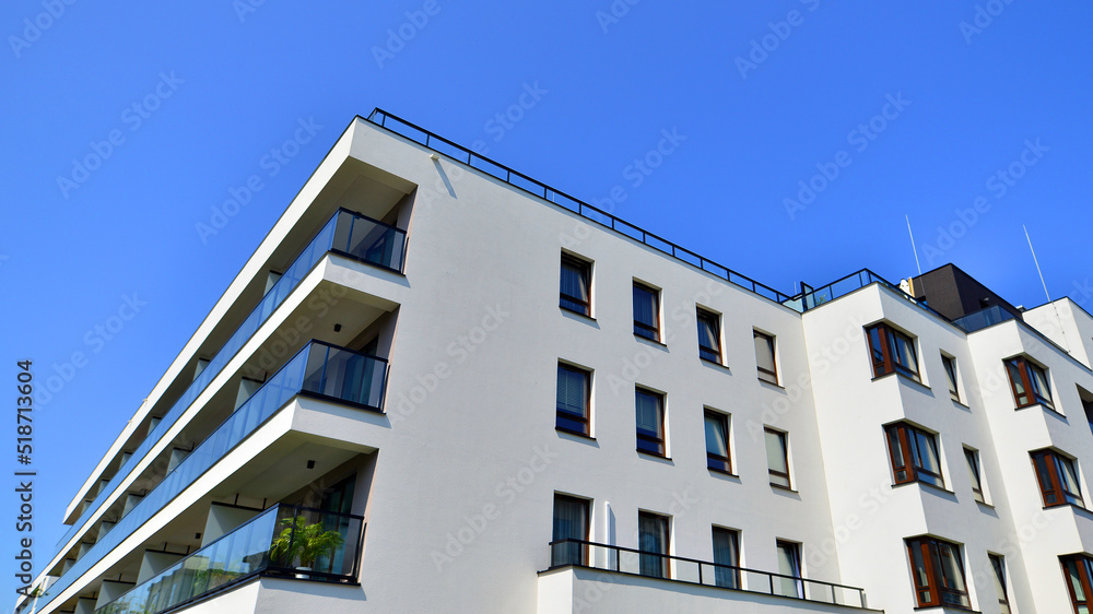 Exterior of new apartment buildings on a blue cloudy sky background. No people. Real estate business