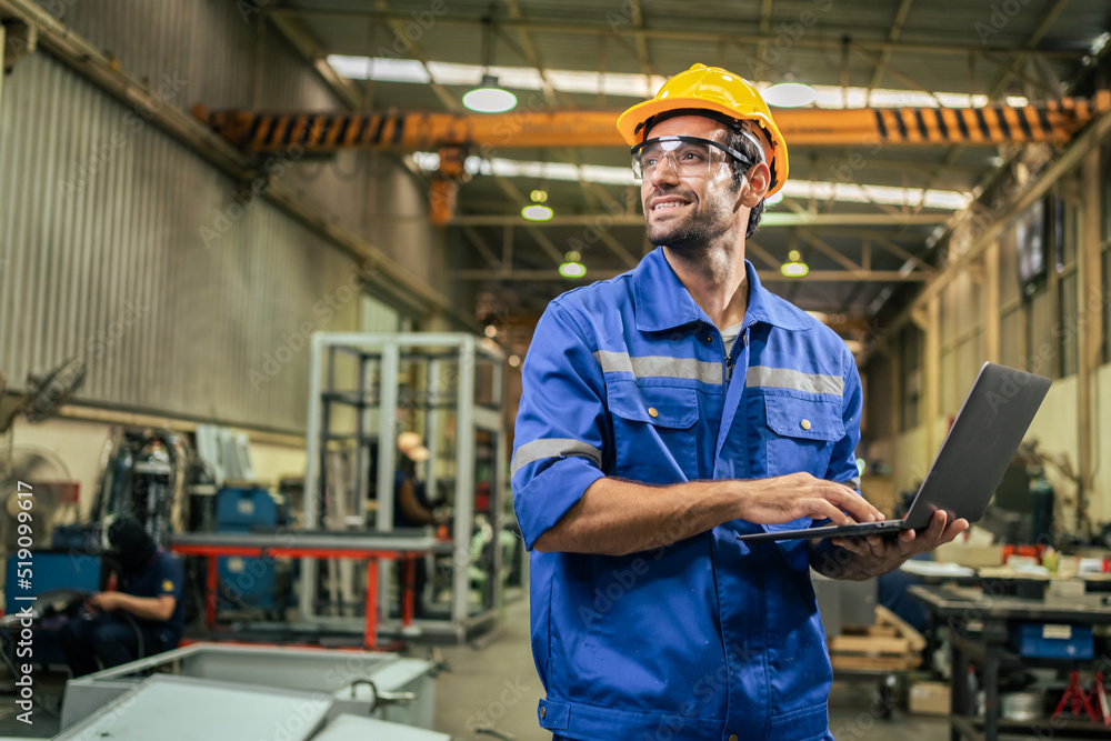 Caucasian handsome male industrial worker work in manufacturing plant.