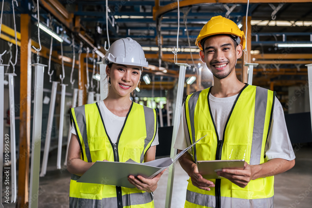 Portrait of Asian male and female industrial worker working in factory