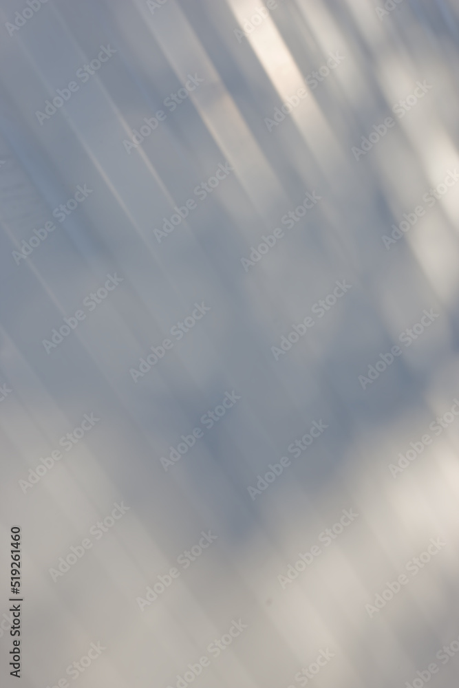 Grey background and copy space with sunlight rays shining through room or on a wall with texture or 