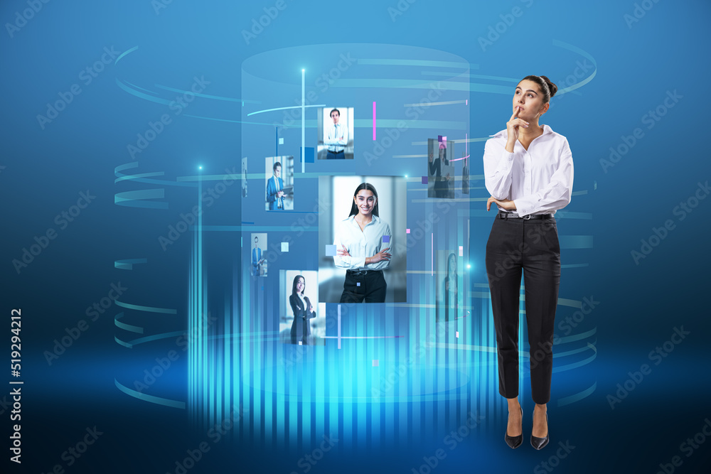 Attractive young european female standing next to abstract digital cylinder picture hologram on blue