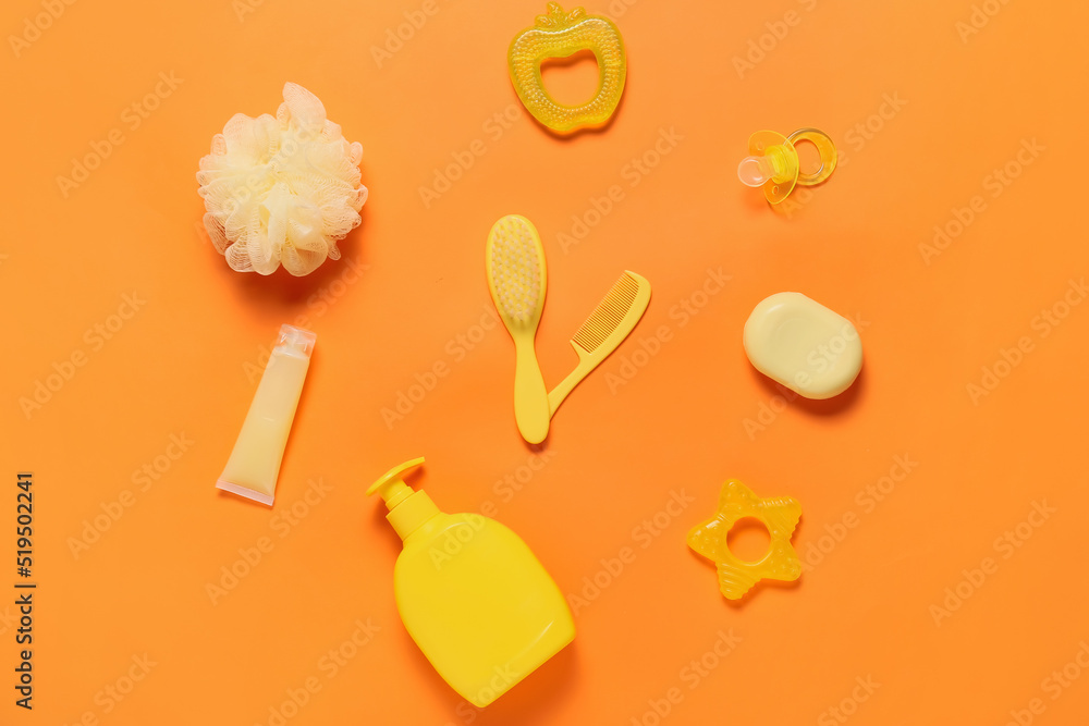 Clock made of bath accessories for baby on color background