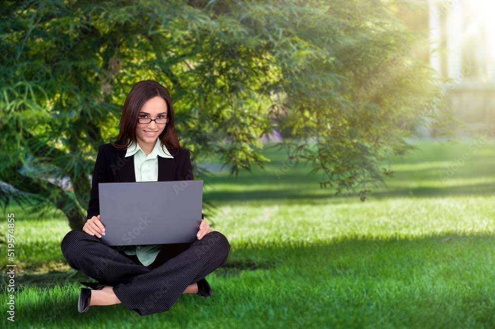 Happy student girl outdoors, preparing for exams and enjoying studying in park or university campus,