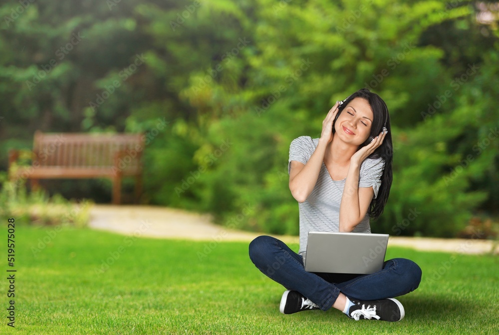 Happy student girl outdoors, preparing for exams and enjoying studying in park or university campus,