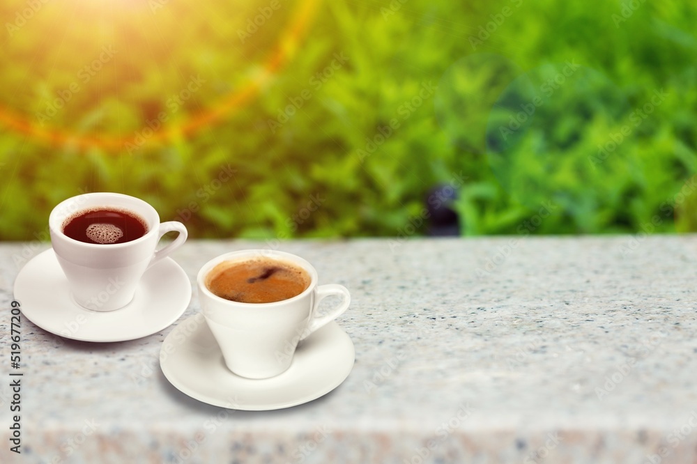 Ceramic cups of aromatic coffee with foam on the table in cafe