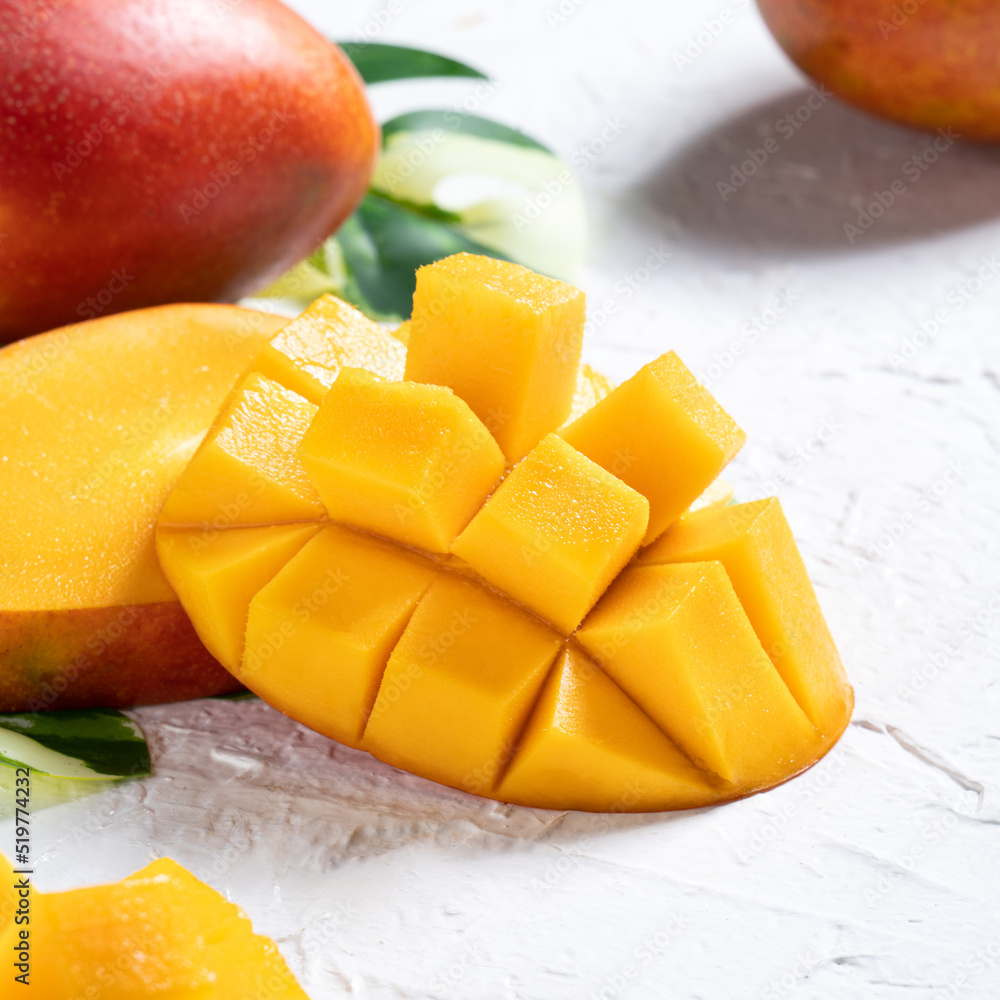 Mango background design concept. Top view Diced fresh mango fruit on white table.