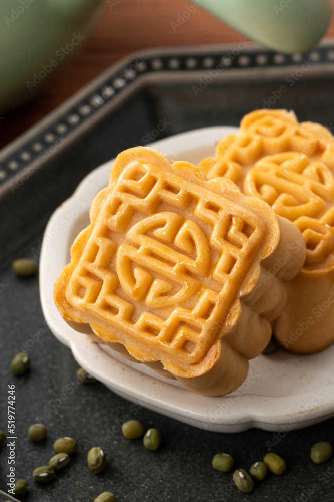 Delicious mung bean moon cake for Mid-Autumn Festival food mooncake on dark wood table background.