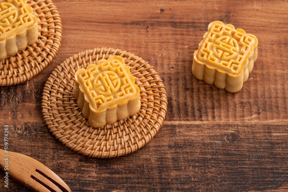 Delicious mung bean moon cake for Mid-Autumn Festival food mooncake on dark wood table background.