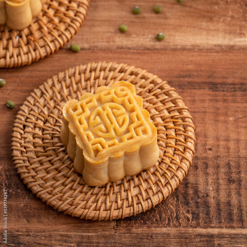 Delicious mung bean moon cake for Mid-Autumn Festival food mooncake on dark wood table background.