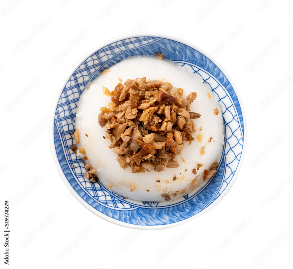 Taiwanese savory rice pudding Wa gui with chopped dried radish and soy sauce isolated on white backg