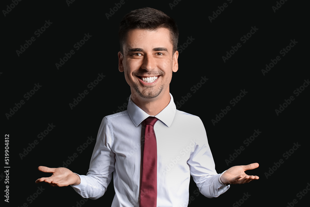 Portrait of funny businessman with big head on dark background