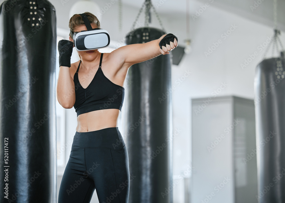 Healthy, fit and active boxing woman with a VR headset to access the metaverse while exercising, tra