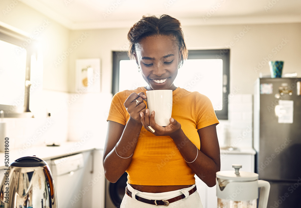 Beautiful, happy and relaxed woman with coffee cup in the morning after waking up on weekend at home