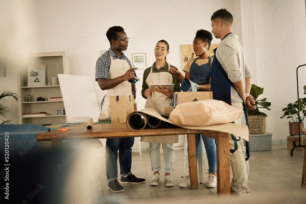 Group of designers doing design teamwork while talking and working on a creative project. A team of 