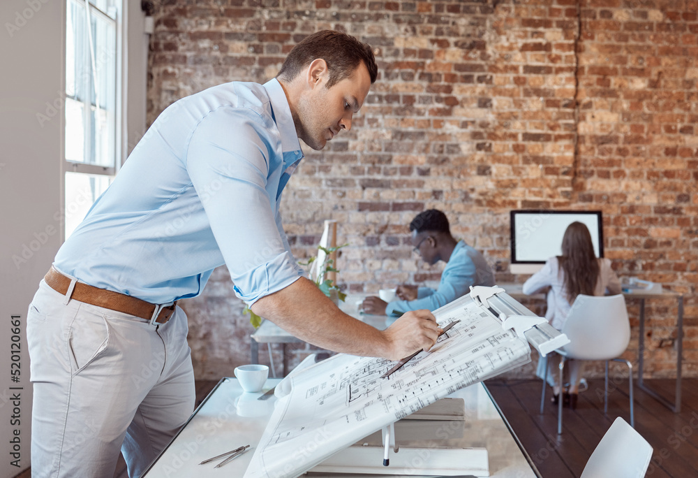 Architect, design engineer or building contractor drawing a plan on a drafting table for a project o