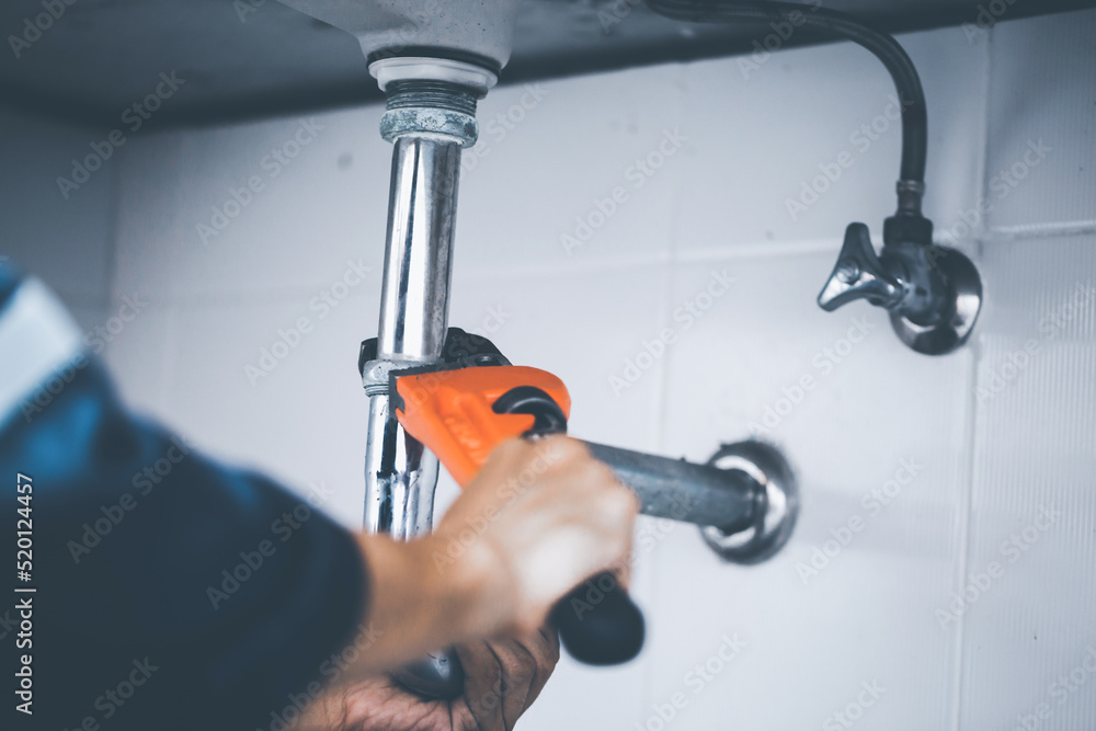 plumber at work in a bathroom, plumbing repair service, assemble