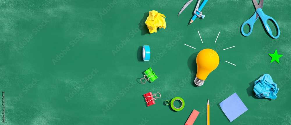 Idea light bulb with school supplies overhead view - flat lay