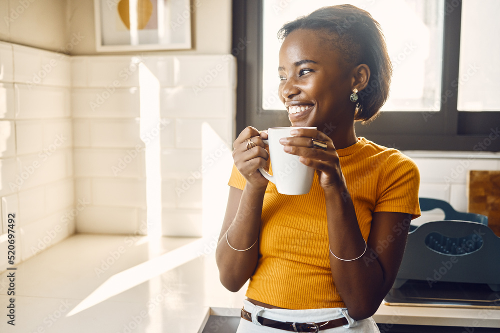 Happy, thinking and relaxed woman drinking coffee on a break in bright sunny kitchen at home. One ca