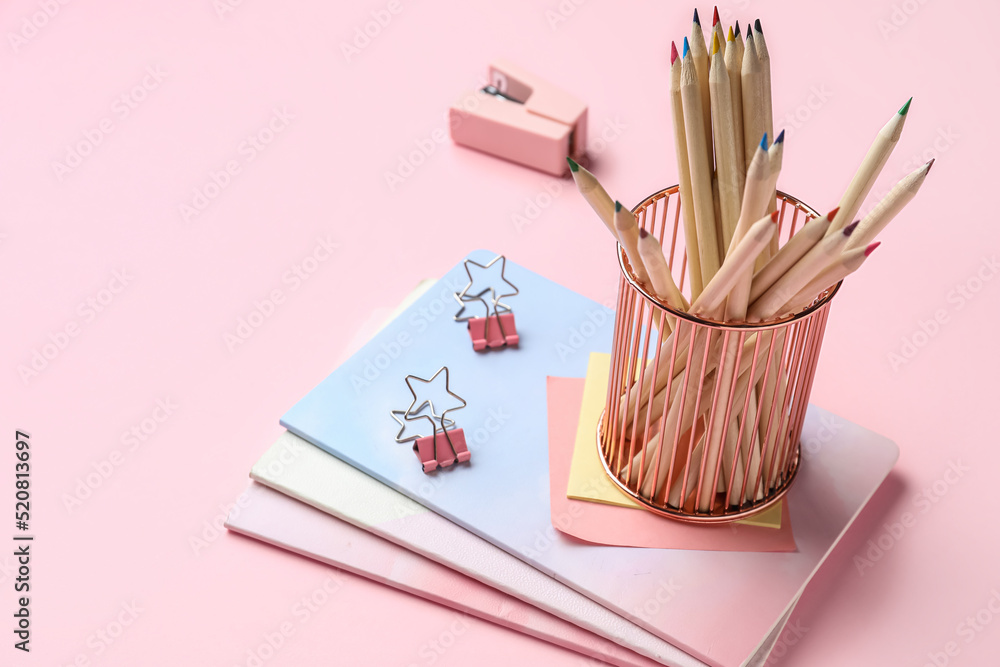 Set of different stationery on pink background