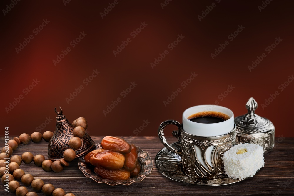 Tasty dates, still life coffee in a oriental cup served with sweet dates on wooden desk