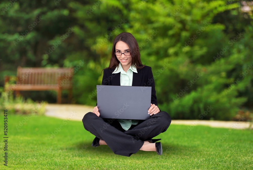 Happy student girl outdoors, preparing for exams and enjoying studying in park or university campus,