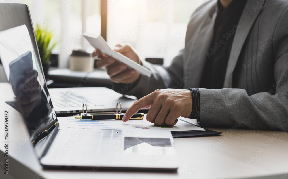 Businessman working about financial with calculator at office to calculate expenses. Accountant calc