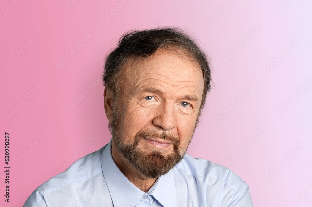 Nice old grey man posing on the color background