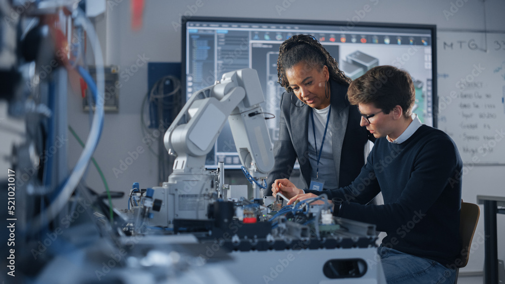 Male Student Engineer Discussing Ideas with Black Teacher while Working with Computer Processor. Man