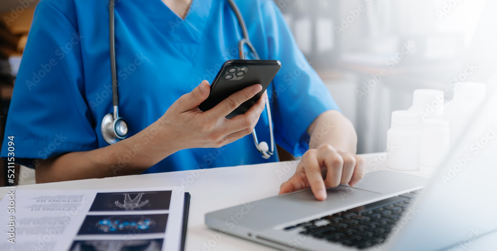 Cropped shot of young female doctor summarises patient charts with digital tablet in her office room