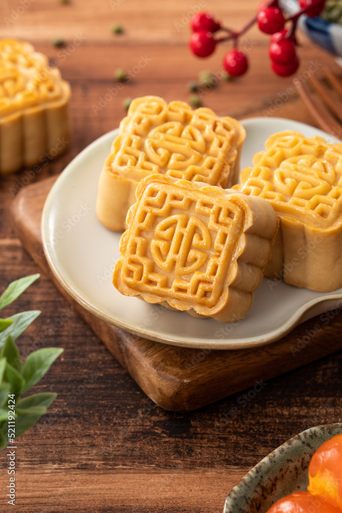 Delicious mung bean moon cake for Mid-Autumn Festival food mooncake on dark wood table background.