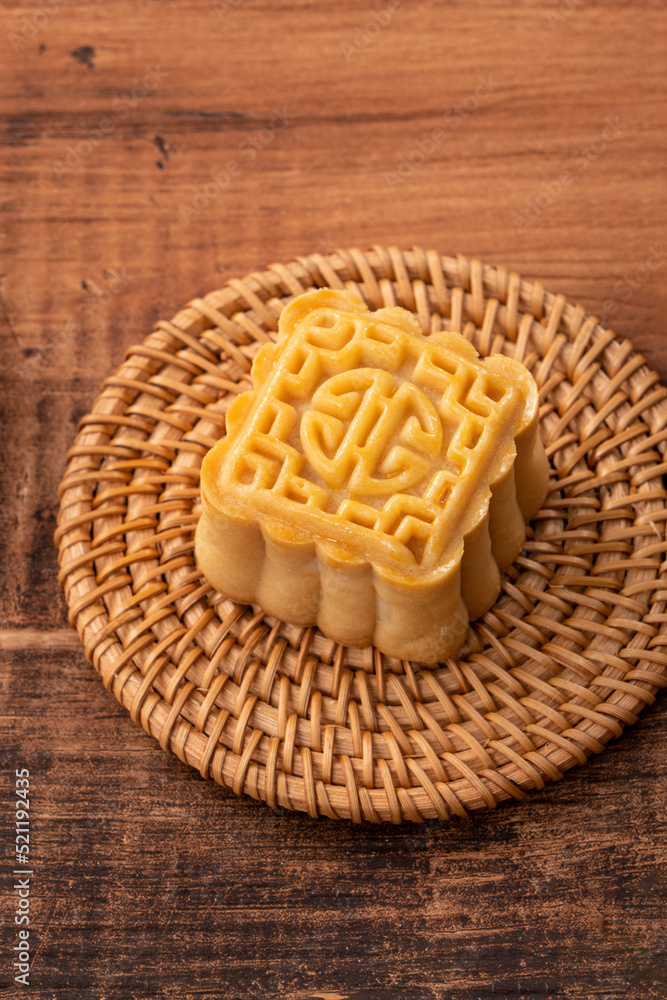 Delicious mung bean moon cake for Mid-Autumn Festival food mooncake on dark wood table background.