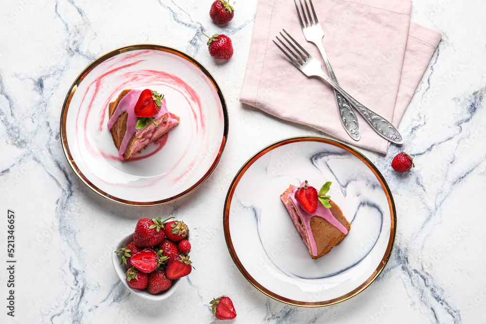 Composition with plates of tasty strawberry cake and berries on light background