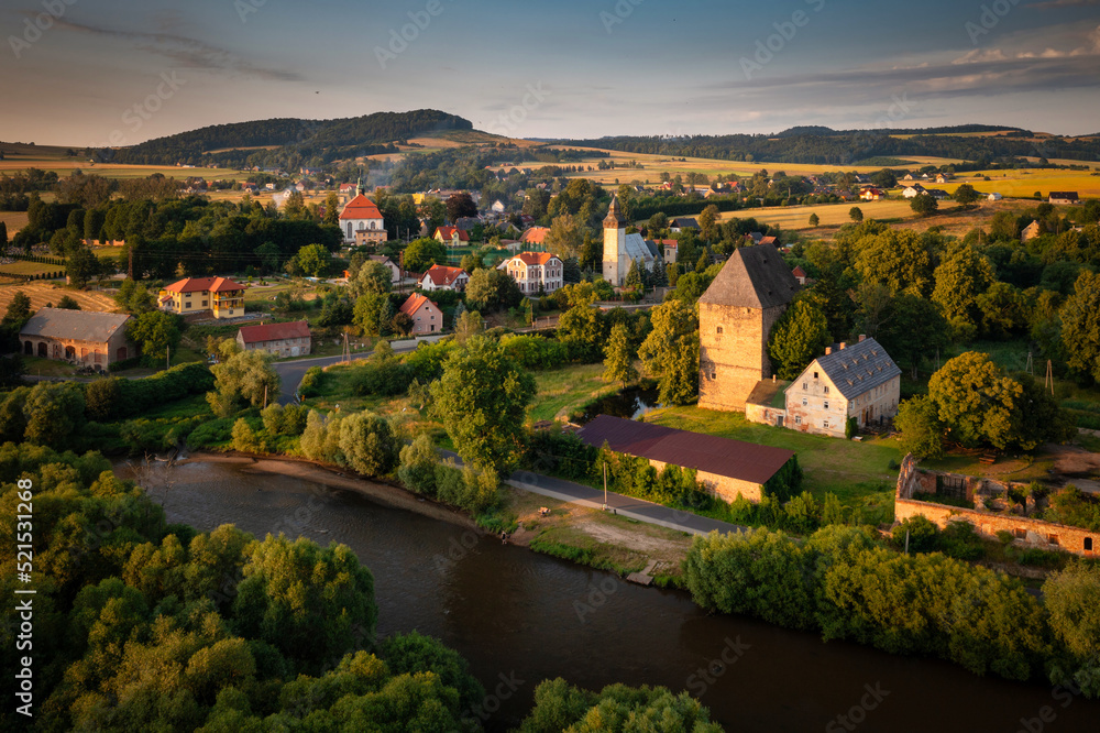 The gothic Siedlecin Ducal Tower illuminated by the setting sun in the Bobr Valley Landscape Park, L