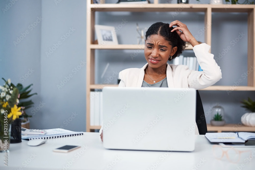 Confused, stressed and angry business woman reading email and scratching her head thinking in her of