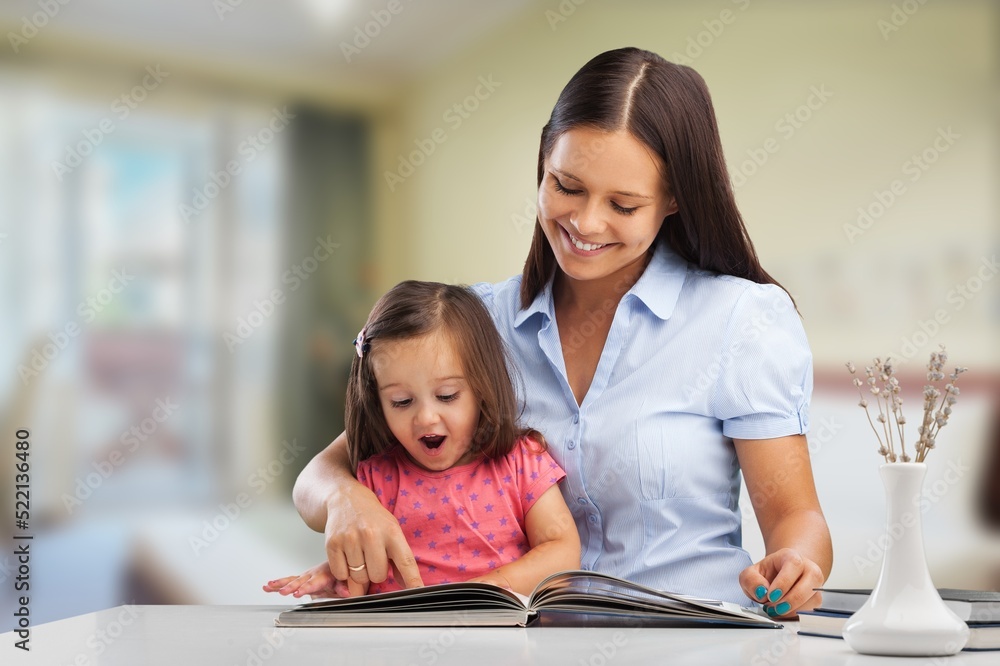 Happy mother and child having fun playing games at home - Family time together