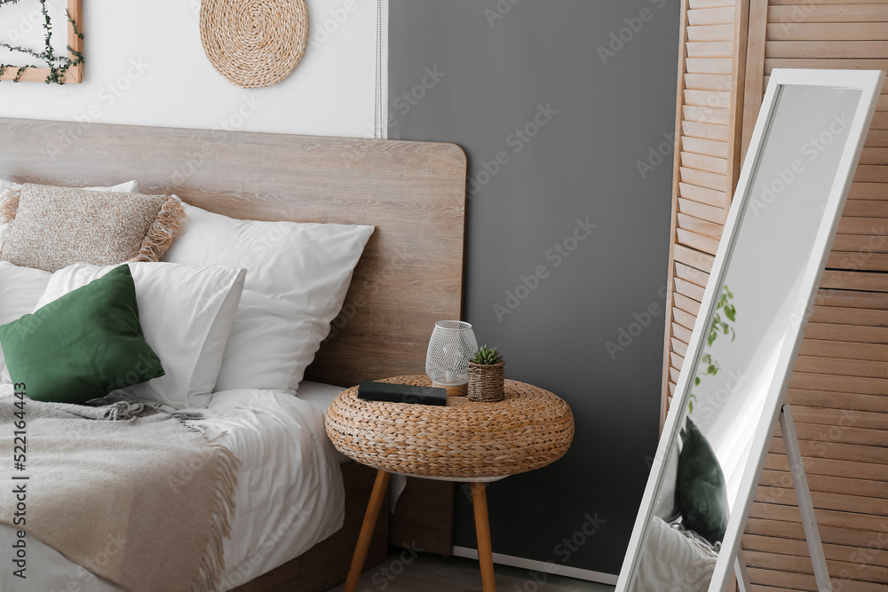 Interior of cozy bedroom with table and mirror