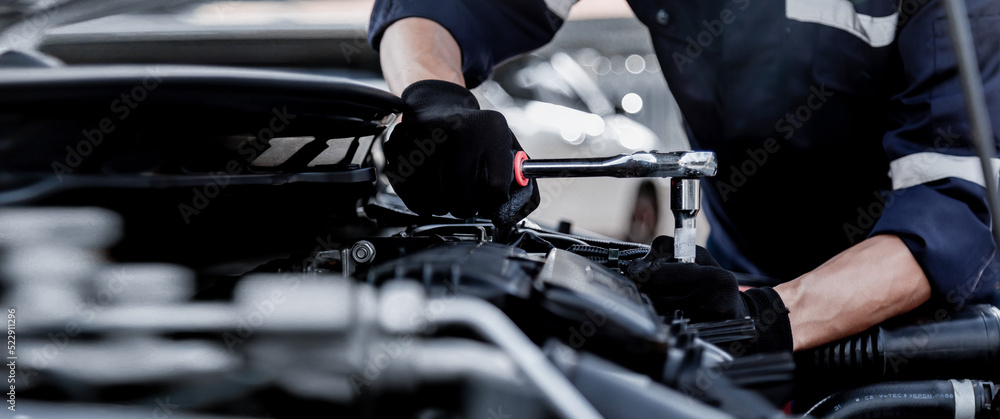 Car care maintenance and servicing, Close-up hand technician auto mechanic using the wrench to repai