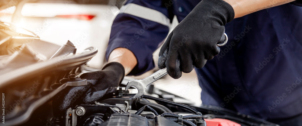 Car care maintenance and servicing, Close-up hand technician auto mechanic using the wrench to repai