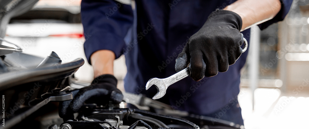 Car care maintenance and servicing, Close-up hand technician auto mechanic using the wrench to repai