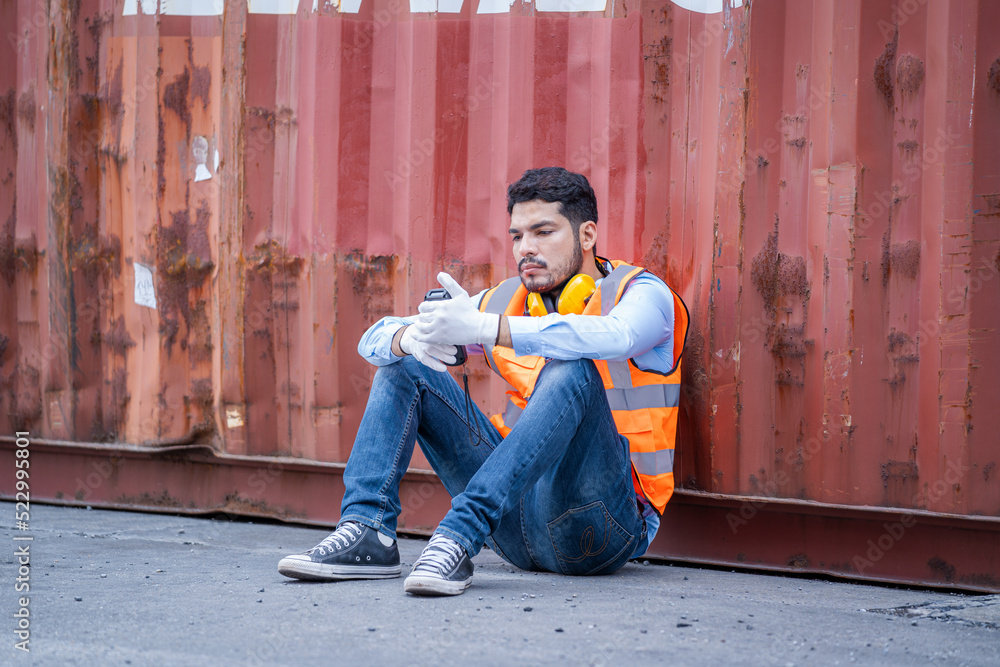 Cargo container worker rests in the container yard warehouse.