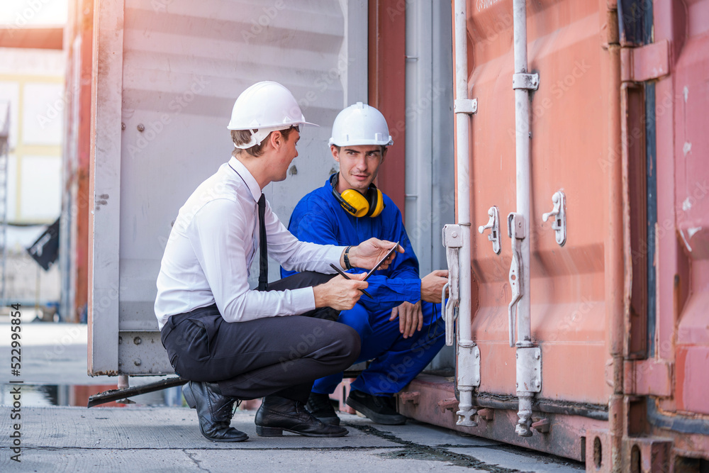 Businessman and Technicians or engineer work at Container cargo site check up goods in container.