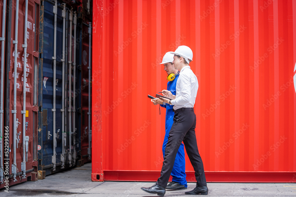 Businessman and Technicians or engineer work at Container cargo site check up goods in container.