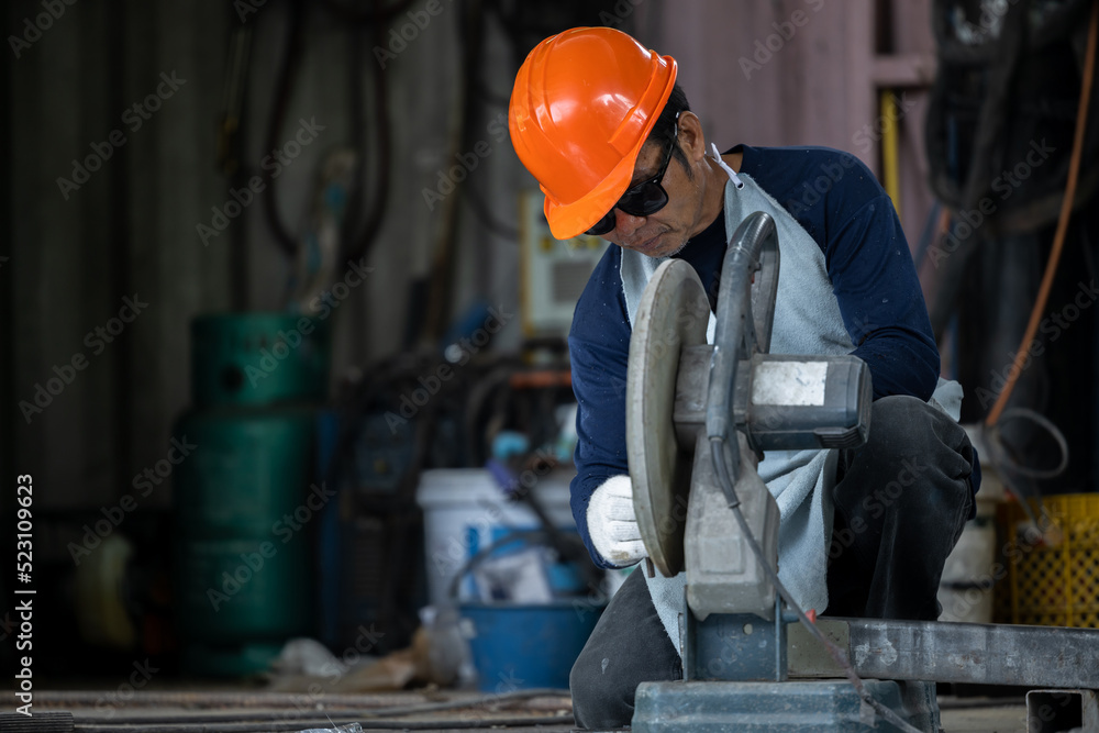 Industrial worker using electric grinder cutting metal, Electric grinder cutting metal bright sparks