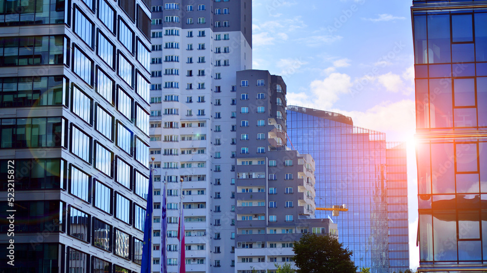  Modern glass facade against blue sky. Bottom view of a  building in the business district. Low angl