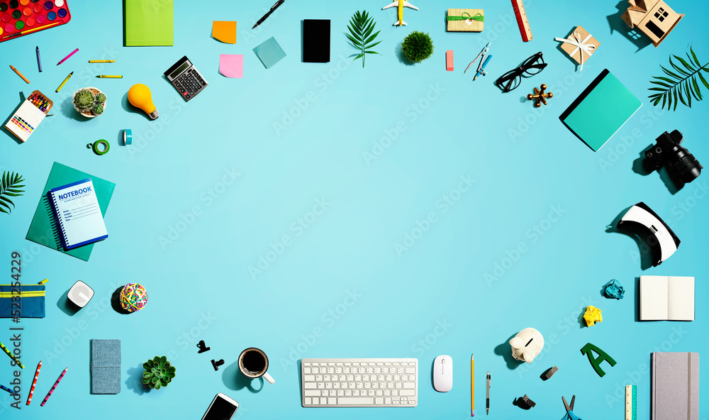 Collection of electronic gadgets and office supplies - flat lay