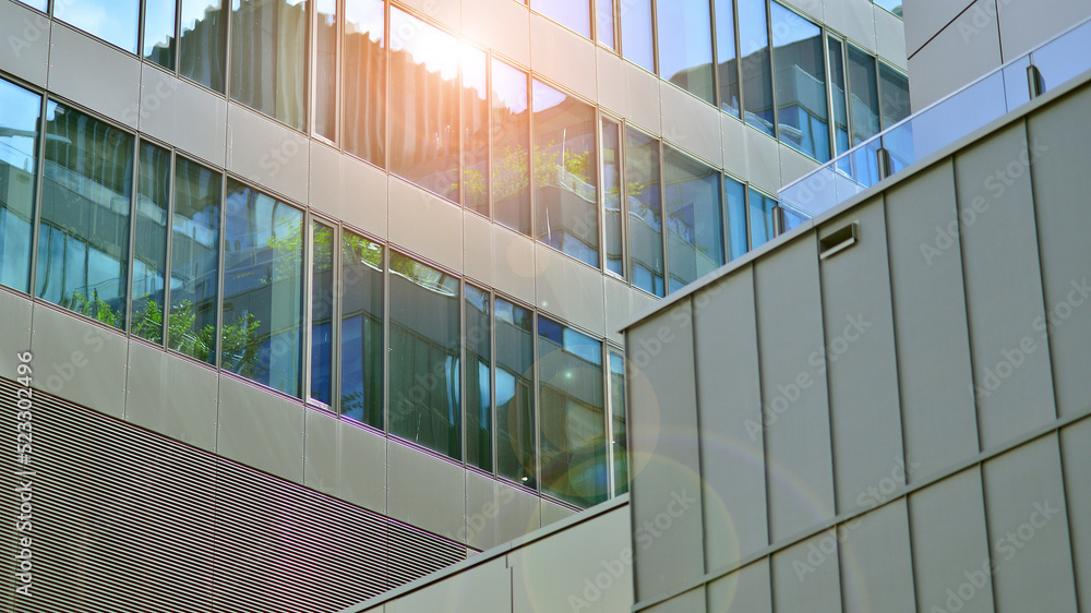 Architecture details. Modern glass building facade in sunny day. Business background.