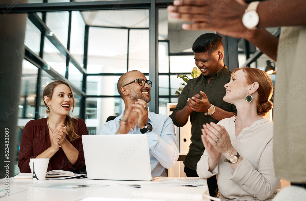 Excited business people clapping in meeting, celebrating success and cheering for good teamwork whil