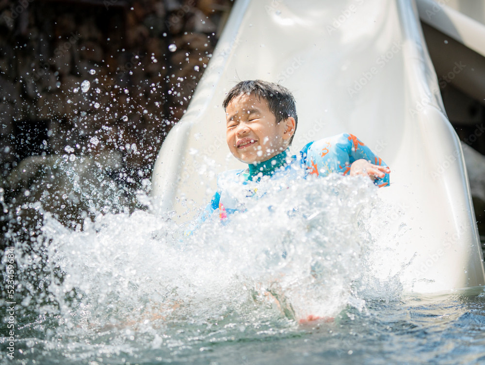 Asian boy play on the  slider water